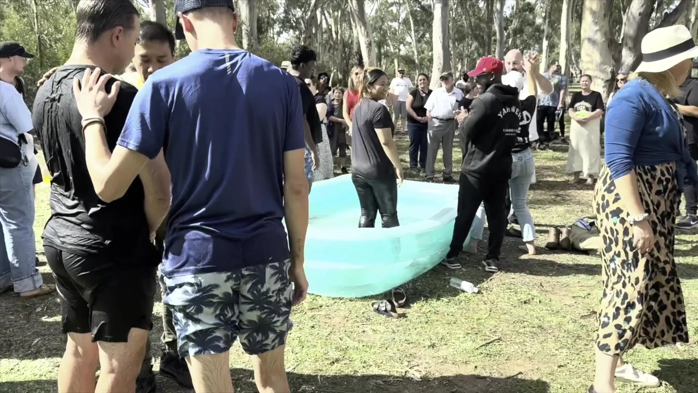 A crowd gathered for an outdoor baptism