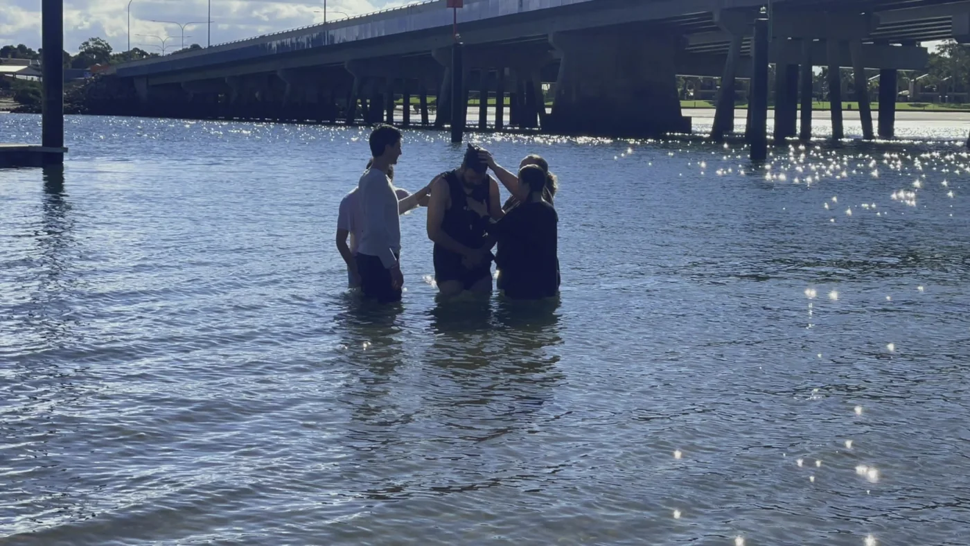 A new believer being baptised in a river