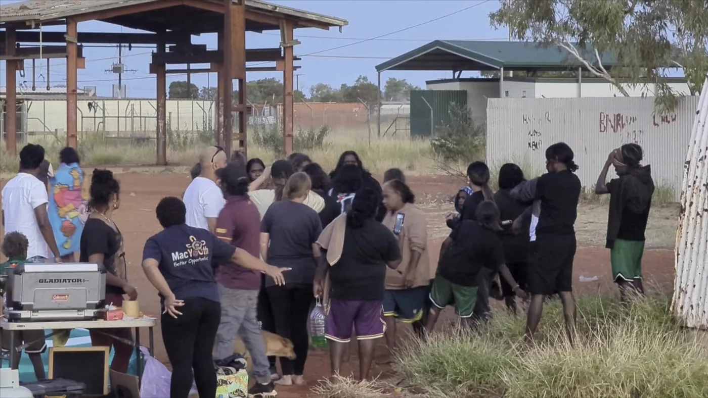 A DMI team gathered with the community in the Northern Territory