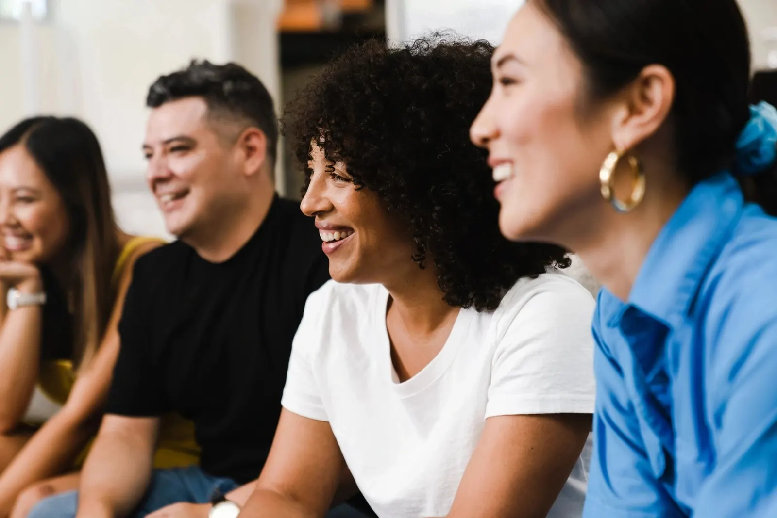 Friends laughing together in a living room