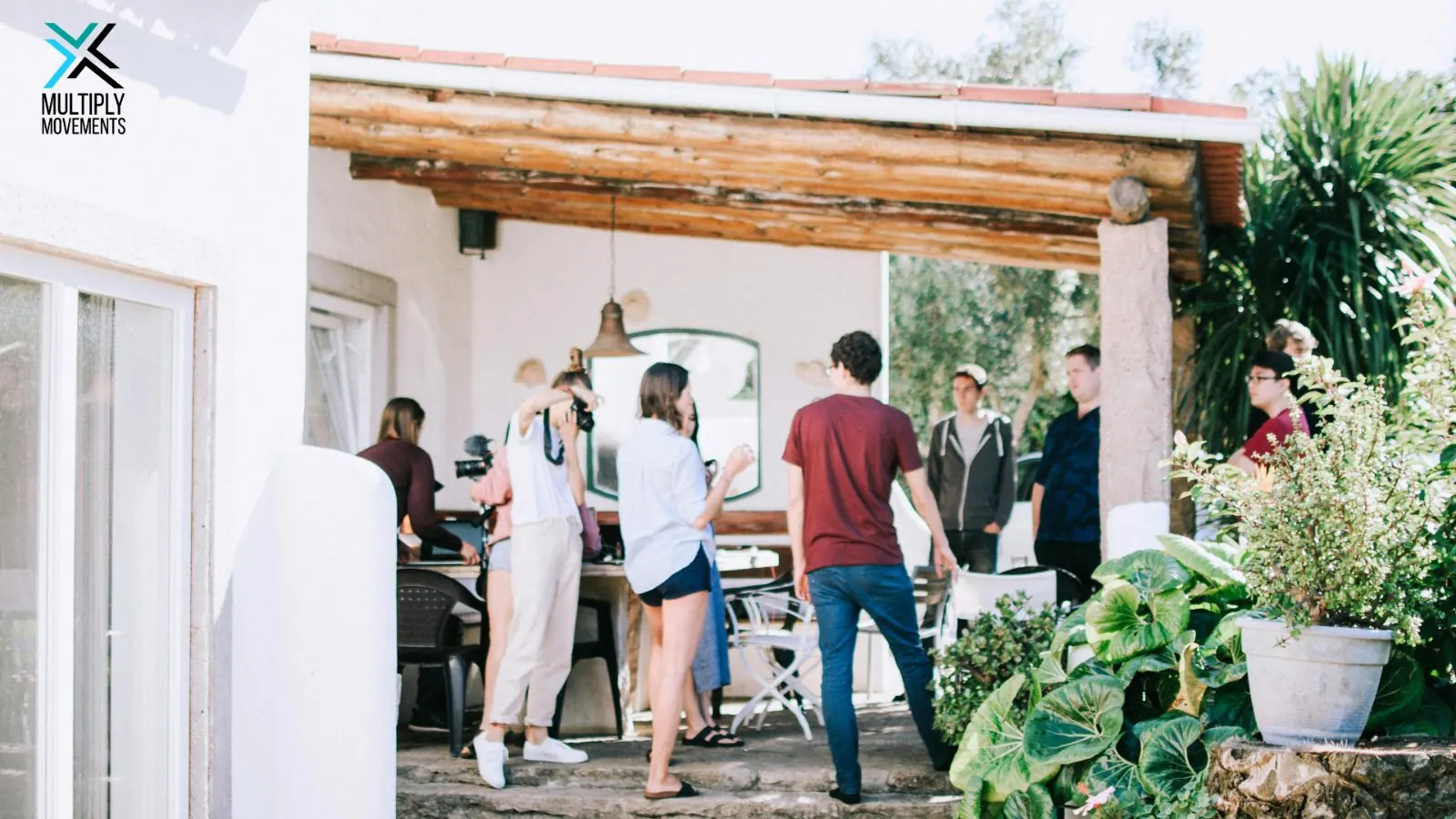 People arriving at a gathering on a home patio